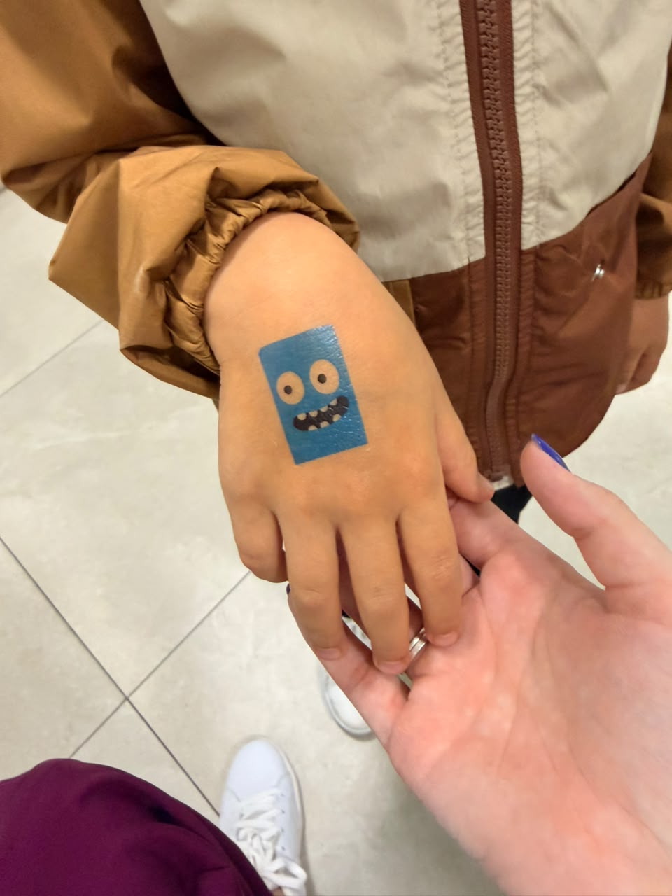 Adesivo infantil na mão de uma paciente